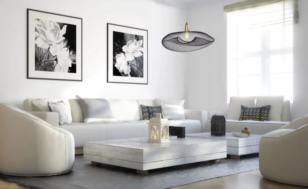 Eine Wohnszene mit weißer und schwarzer Farbpalette mit luftigem pendelleuchte als Akzentbeleuchtung